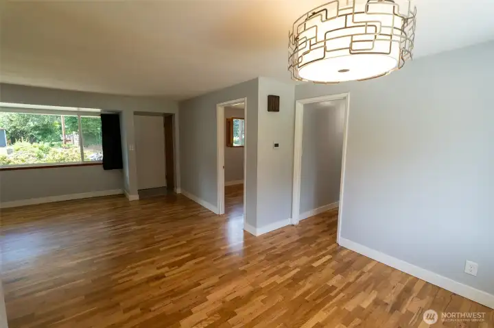 When you enter the front door, you will find this large living room with gorgeous flooring, large windows, updated light fixtures and one bedroom facing front.