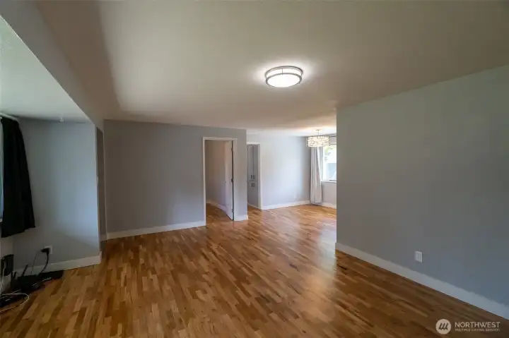 View from the corner of your living room to your dining area, bedroom and hall.