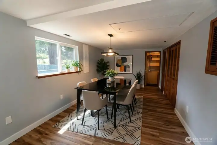 Rec room view shown virtually staged as a dining room.