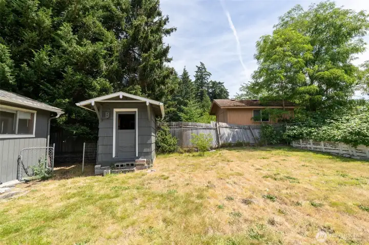 Backyard view showing shed and "guest cottage" to your left, lots of room back here!