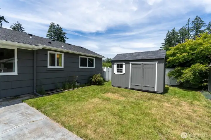View of the back of the home and one of four outbuildings.
