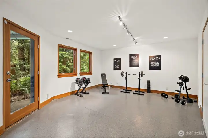 Fitness or bonus room with epoxy floors and extra storage room