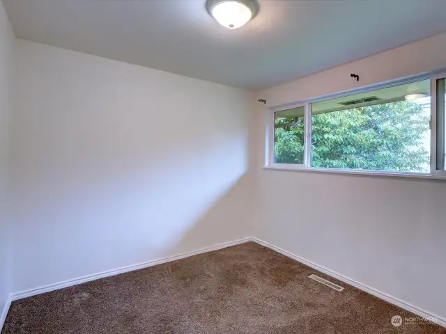 Upper level bedroom facing backyard.