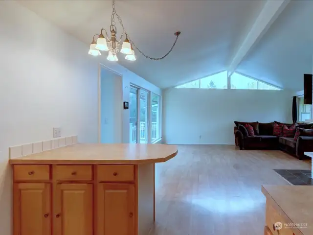 View from kitchen looking into living room. Sun room and deck access on left.