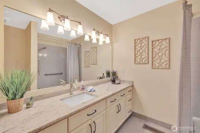 Guest full bath with refaced cabinets and granite countertops.