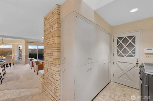 The back side of the fireplace is filled with additional storage. The cabinet closest to the Dutch door houses the water heater.