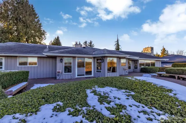 Rear View. Garden raised boxes to the left. Sitting benches surround patio.