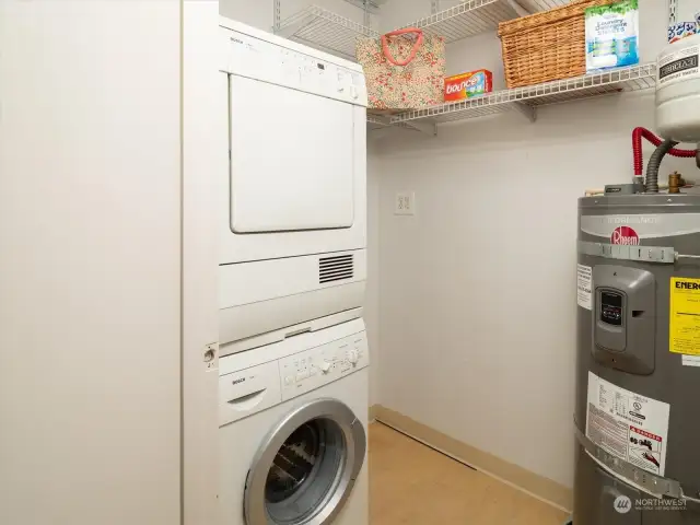 This efficient laundry room in your own unit has a spot for everything, with stacking washer & dryer.