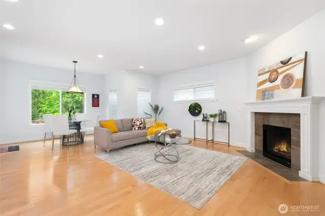 Family room connects to breakfast nook, boasting serene greenbelt view & seamless indoor-outdoor living.