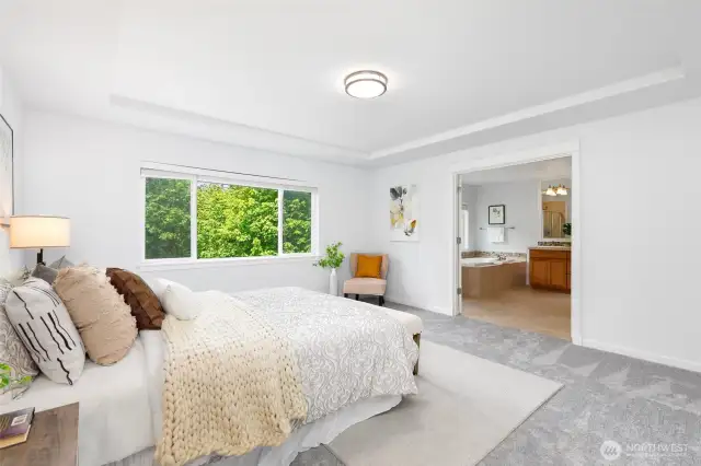 Spa-inspired luxury master ensuite w/ soothing vista.