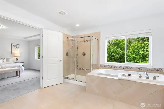 Spa-inspired luxury master ensuite w/ soothing vista.