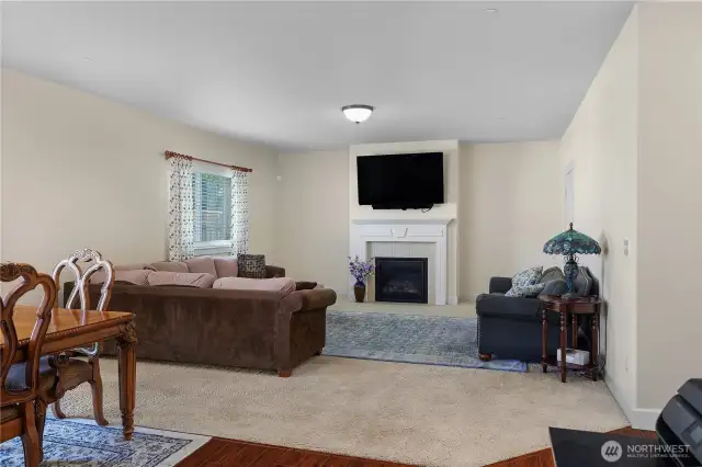 Great room with gas fireplace and tile surround.