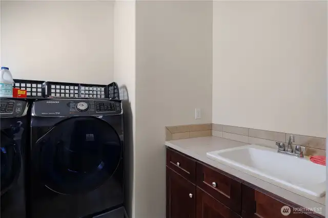 Main floor utility room with laundry sink.