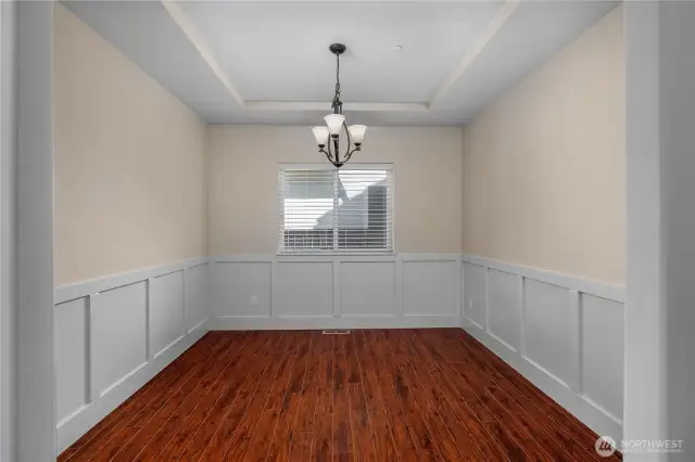 Formal dining room with wainscoting.