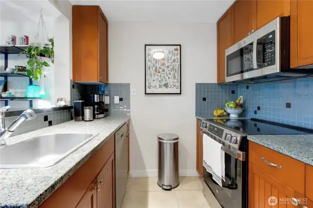 galley kitchen with tile backsplash and counters