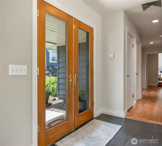French door entry with ceramic tile floors
