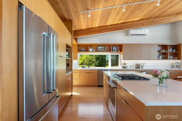 Quartz counters in this expansive kitchen with so much storage.