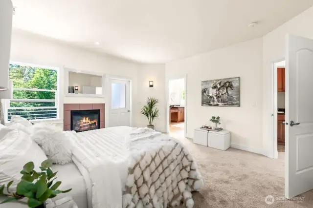 Opulent primary bedroom suite on the upper level with the gas fireplace.