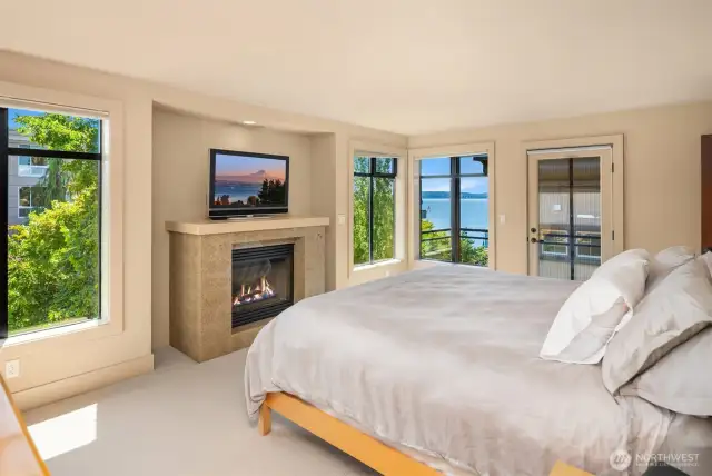 Primary Suite - with views galore, a private balcony, the 3rd gas fireplace in the house, and a spa like bathroom with soaking tub and shower...and walk-in closet, with laundry!