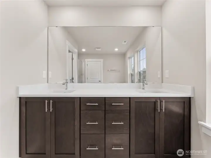 Double sink vanity, solid wood cabinets, quartz counters with undermount sinks. Actual home is under construction and materials, colors, and finishes will vary. See site agent for details.
