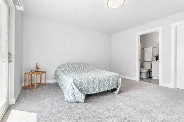 Primary bedroom features a private bathroom and ample storage provided by the walk-in closet.