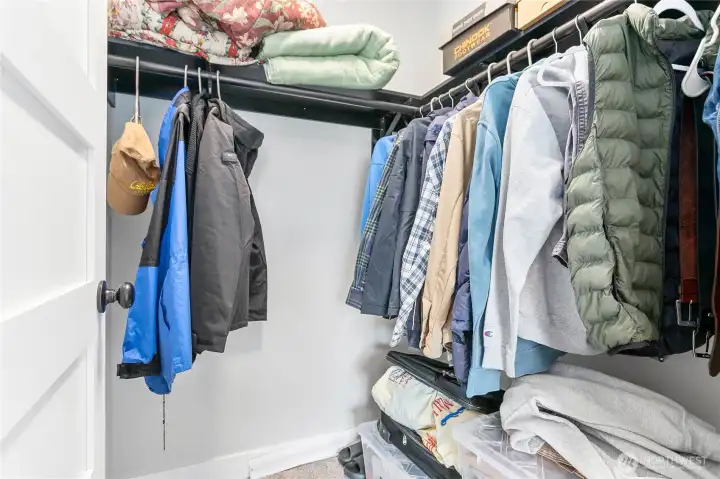 Large primary walk-in closet with ample storage and organization features.