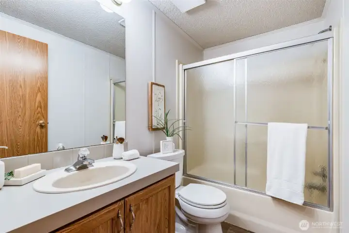 The full hall bathroom is located next to the second and third bedrooms.