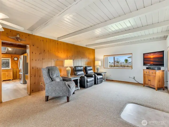The entryway featuring propane stove, classic wood paneling and large picture window facing the neighborhood.