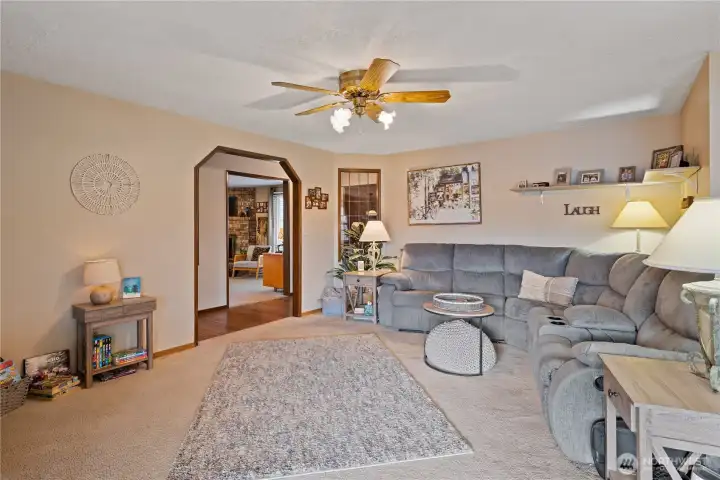 Living room open to the dining room and sliders to the backyard