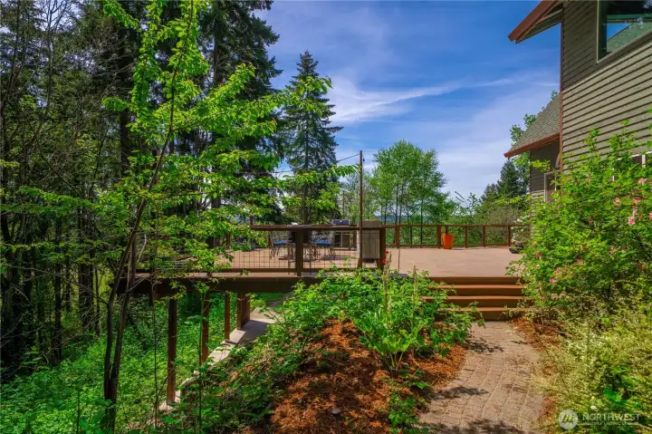 Side yard with access to deck, kitchen and main floor.