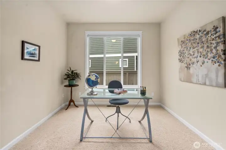 Versatile main-level room just off the kitchen--ideal for a home office, study, or quiet retreat.