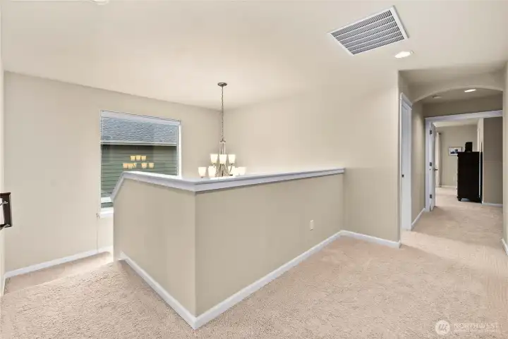 Upstairs landing offers flexible space ideal for a reading nook, homework station, or play area.
