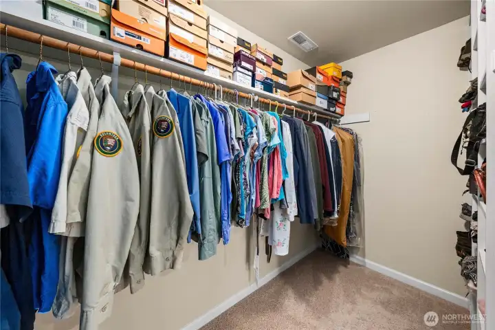 Large walk-in closet with generous shelving and hanging space for excellent organization.