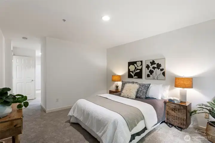 Large main floor primary suite with walk in closet and large bathroom