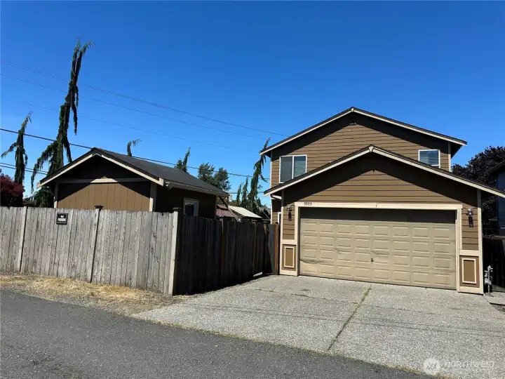 Driveway and garage has access from street behind home.