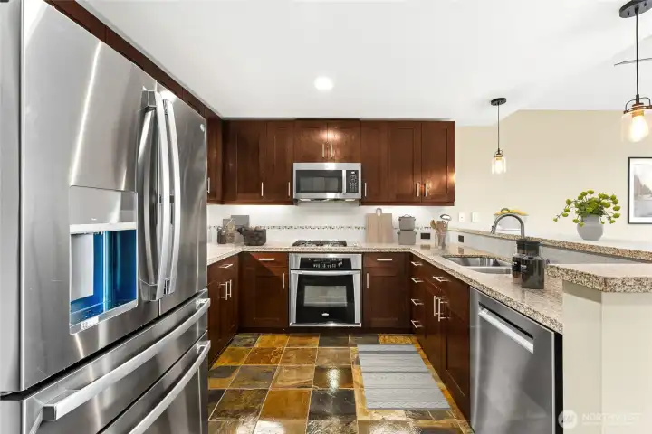 The chef-sized kitchen gleams with new stainless steel appliances.