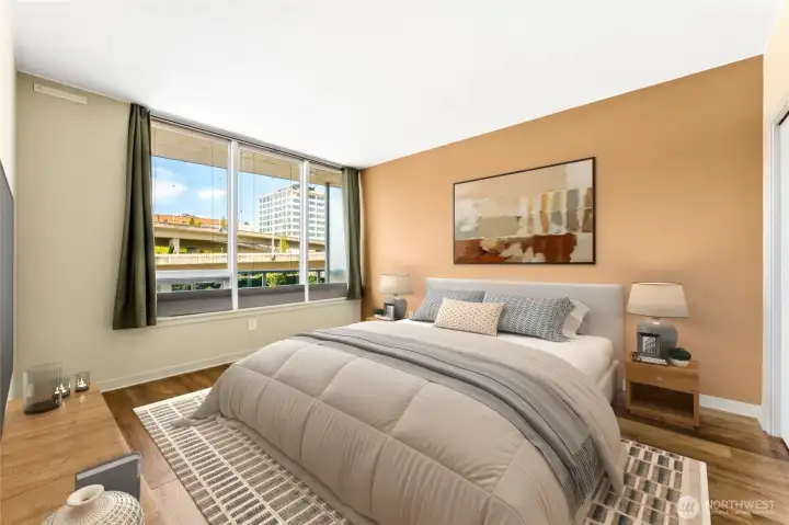 The bedroom easily accomodates a king size bed as shown here with virtual staging.