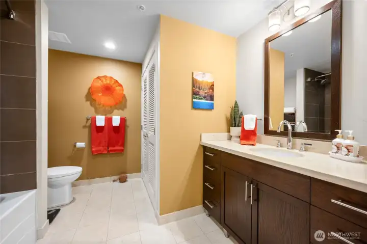 The bathroom has marble floors and vanity.