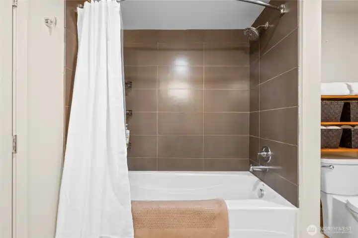Your six foot soaker tub is surrounded by ceramic tile walls.