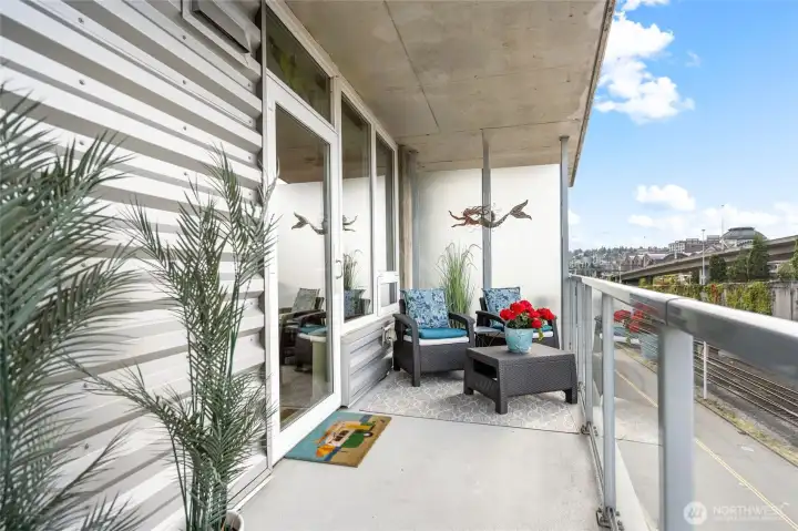 The deck for this condo runs the entire width of the home. Enjoy this view of the city, always in motion.