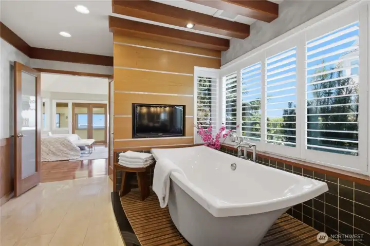 Soaking tub in primary bath with built-in TV. Soaking tub in primary bath with built-in TV.