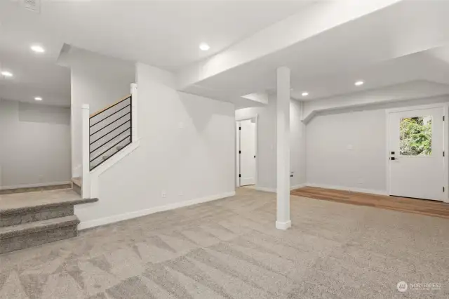 Stairs lead down from the kitchen to this spacious basement - offering a large den, living area, outdoor access, a 3/4 bath, a 4th bedroom with walk-in closet, plus ample additional storage. Perfect for a mother-in-law suite.