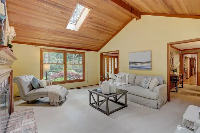 Just inside the entry door, the living room has the cozy cedar planked ceilings and skylights for additional light