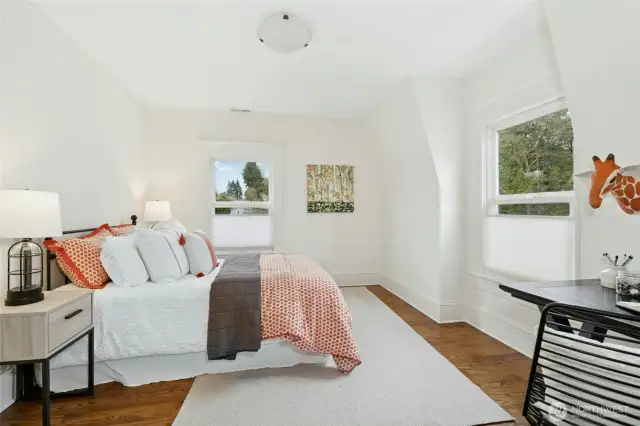 The front bedroom with fir floors, dormers and a wall of closets.