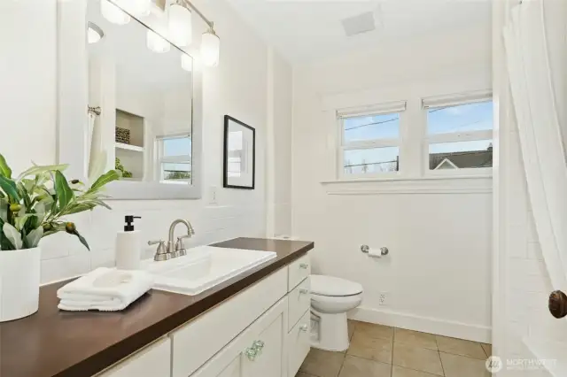 The 2nd floor bathroom has storage and plenty of space.