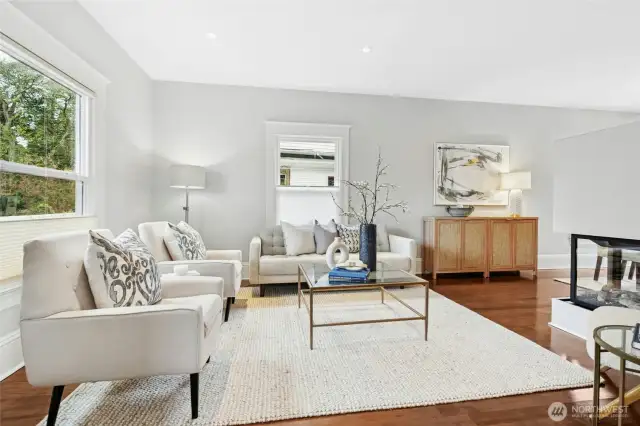 The living room with high ceilings and hardwood floors.