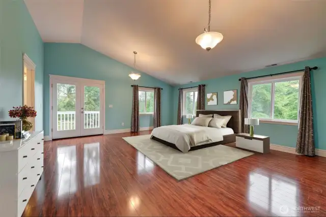 Primary suite with private deck, vaulted ceiling, walk-in closet & 5 piece bathroom.