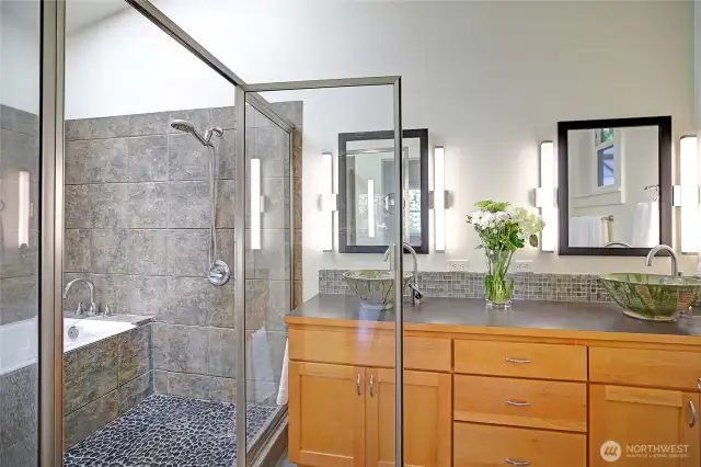 Keep your toes and feet toasty with the heated floors in the gorgeous primary bathroom with dual sinks designed & featured by a local artist.