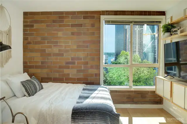 Bedroom area with water and skyline views