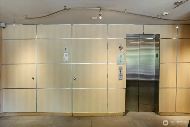 Stylish paneled wall hides doors in lobby